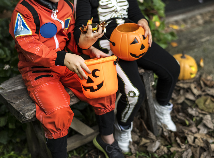 Little children trick or treating on Halloween