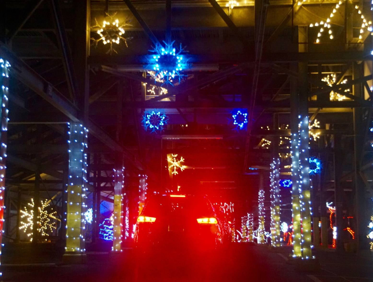 Drive-through Christmas lights display at night